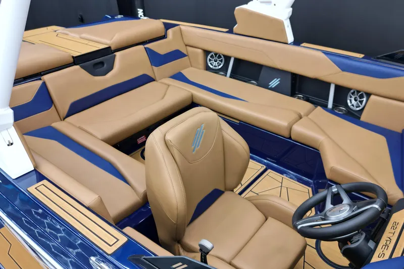 Slide: The Image of 2024 ATX Surf Boats 22 Type-S interior with tan and blue seating, modern design. - 7
