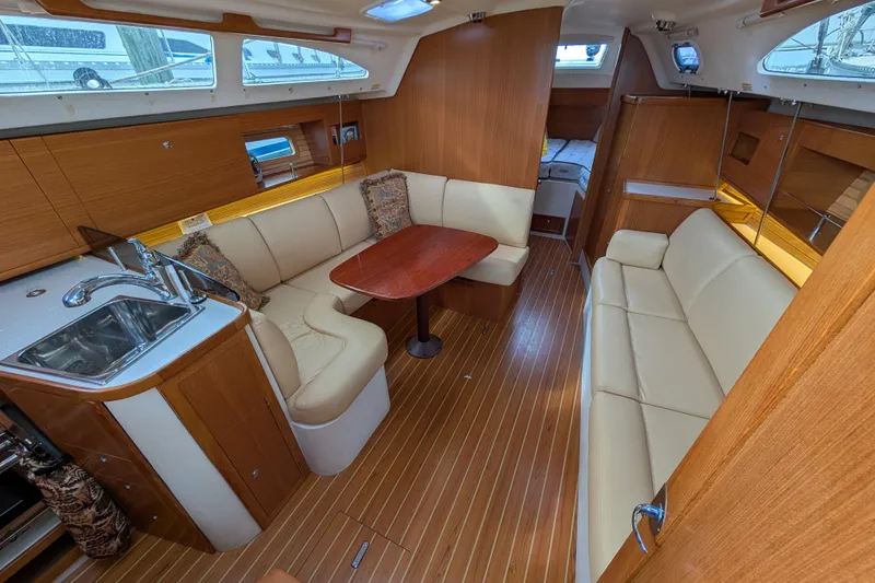 Slide: The Image of Interior of 2021 Catalina 315 sailboat with cozy seating and wooden finishes. - 1