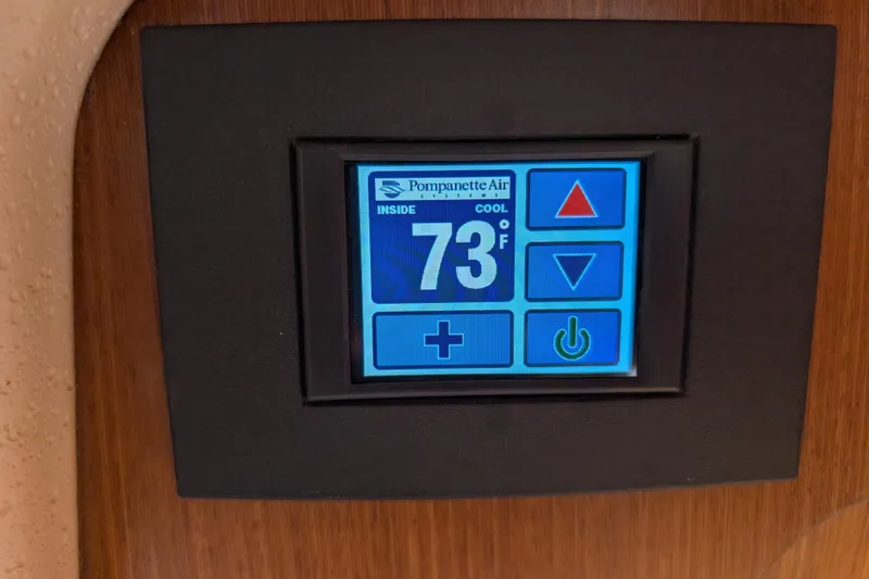 Slide: The Image of Digital thermostat display in 2021 Catalina 315, showing 73°F with control buttons. - 12