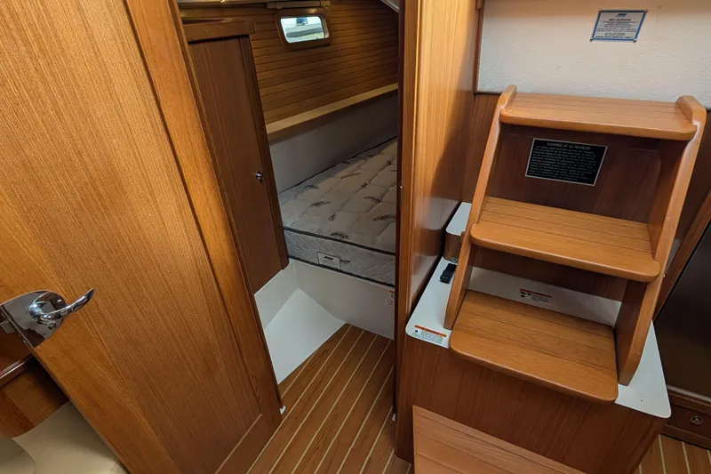 Slide: The Image of 2021 Catalina 315 yacht cabin with wooden interior and comfortable mattress. - 18