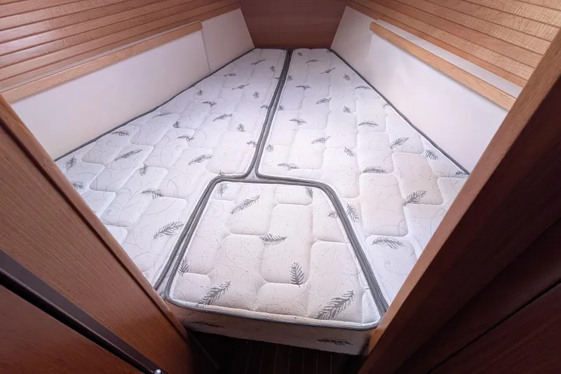 Slide: The Image of V-berth cabin interior of 2021 Catalina 315 sailboat with patterned mattresses. - 20