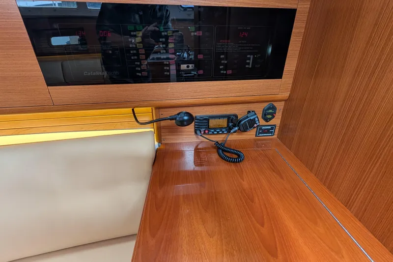 Slide: The Image of 2021 Catalina 315 yacht interior with control panel and communication equipment. - 25