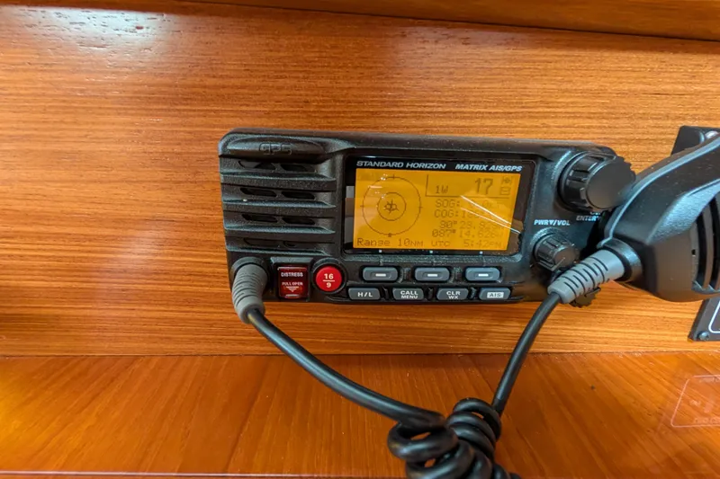 Slide: The Image of VHF radio on 2021 Catalina 315 sailboat, displaying GPS coordinates and settings. - 27