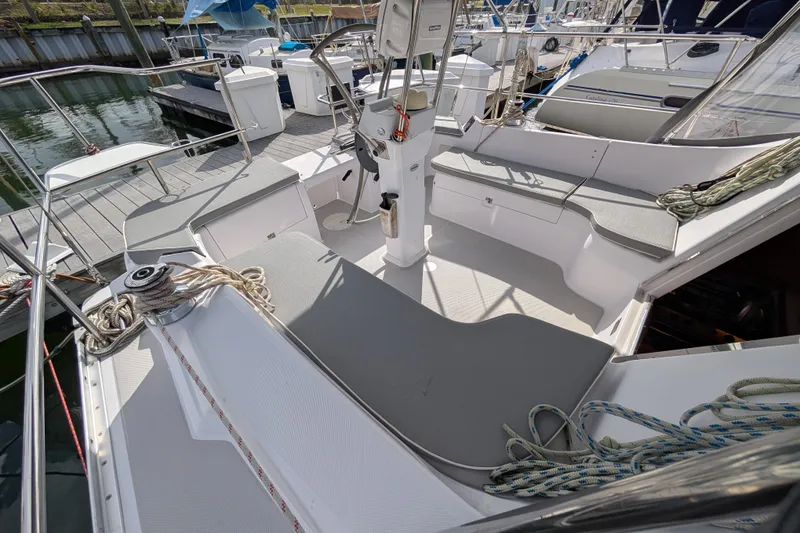 Slide: The Image of 2021 Catalina 315 sailboat cockpit with seating and steering wheel, docked at marina. - 28