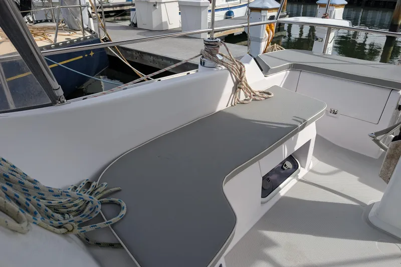 Slide: The Image of 2021 Catalina 315 sailboat cockpit with seating and ropes at a marina. - 32