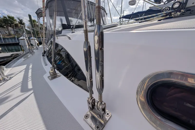 Slide: The Image of 2021 Catalina 315 sailboat docked in marina, featuring sleek design and protective canopy. - 44