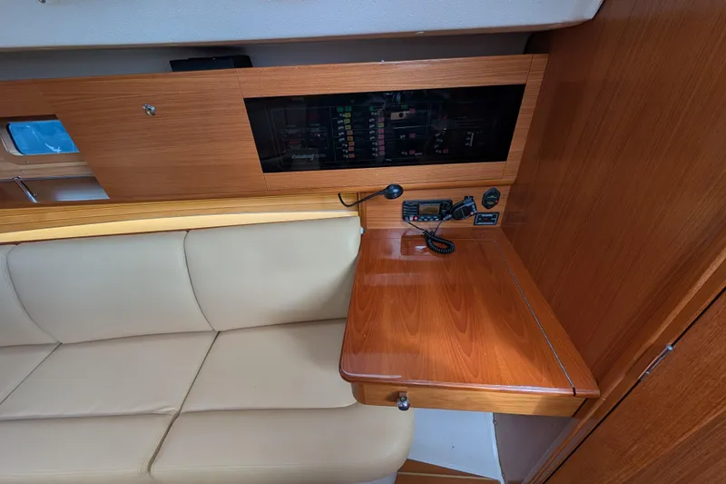 Slide: The Image of 2021 Catalina 315 yacht interior with navigation station and beige seating. - 6