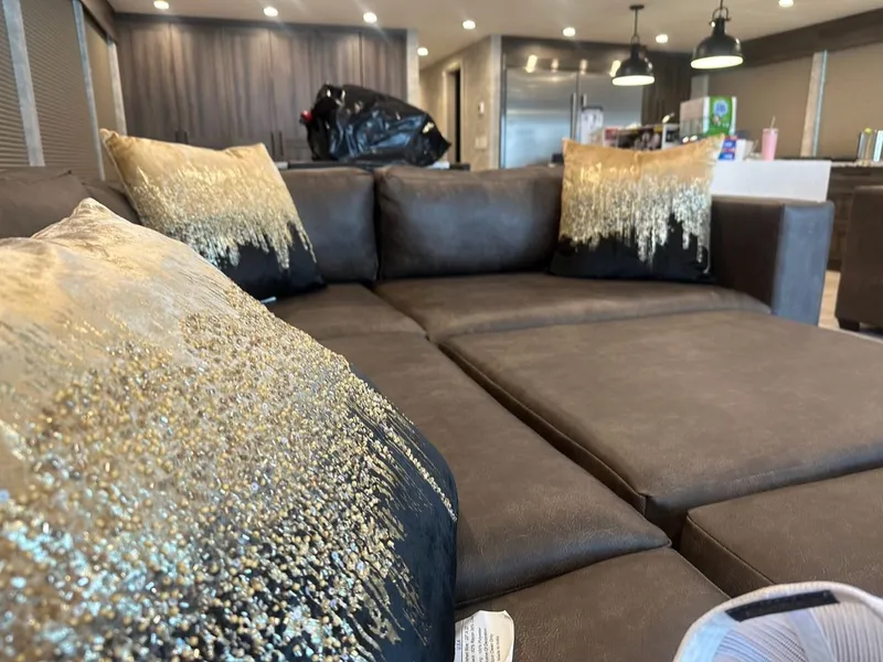 Slide: The Image of Modern living room scene with elegant pillows on brown sofa, Adonia 2023. - 13