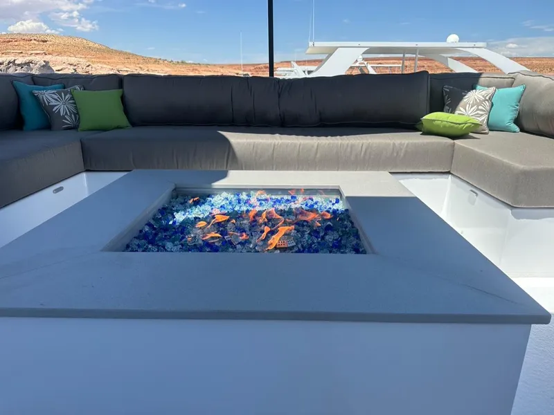 Slide: The Image of Luxurious yacht lounge with fire pit and cushions, Adonia 2023. - 17