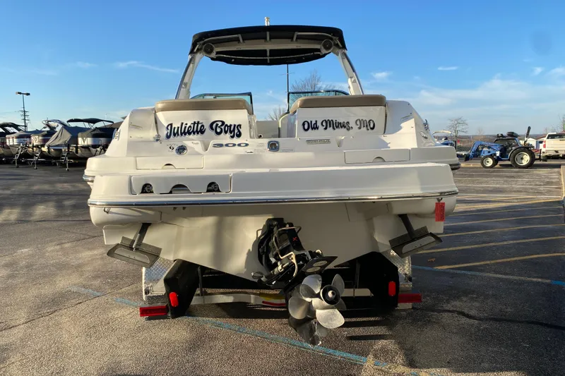 Slide: The Image of 2012 Sea Ray 300 SLX boat in parking lot, rear view with propeller visible. - 15
