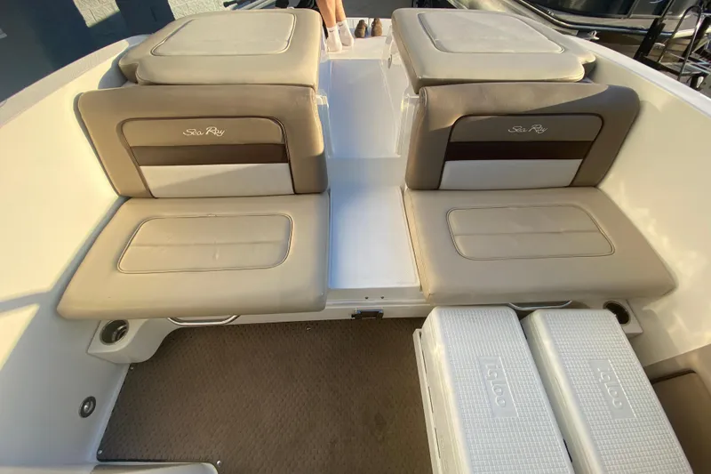 Slide: The Image of 2012 Sea Ray 300 SLX boat interior with cushioned seating and Igloo coolers. - 22