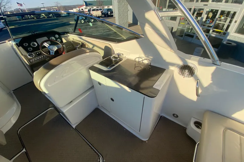Slide: The Image of Interior of 2012 Sea Ray 300 SLX boat with steering wheel and seating area. - 23