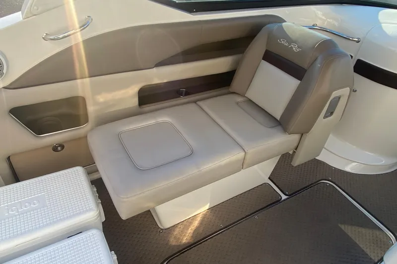 Slide: The Image of Interior seating of a 2012 Sea Ray 300 SLX boat, featuring beige and brown upholstery. - 25
