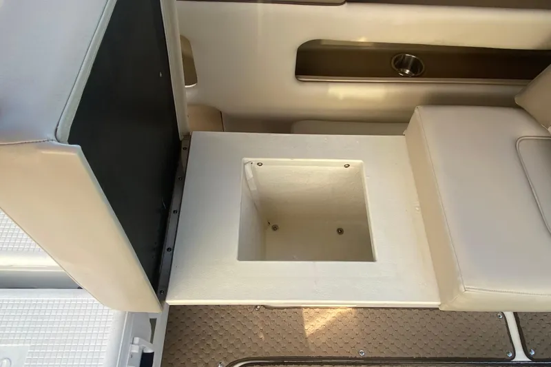 Slide: The Image of 2012 Sea Ray 300 SLX boat interior storage compartment with beige seating. - 26