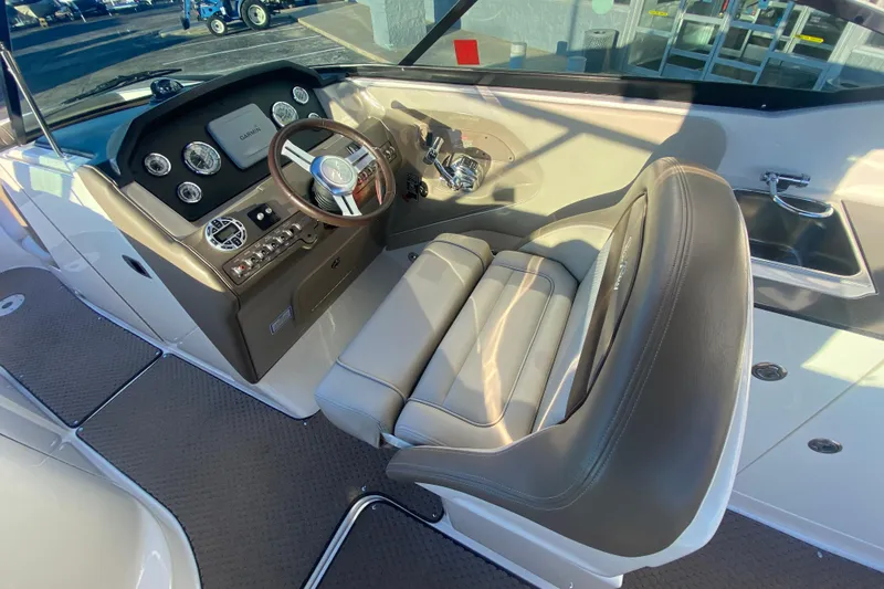 Slide: The Image of 2012 Sea Ray 300 SLX boat cockpit with steering wheel and control panel. - 27
