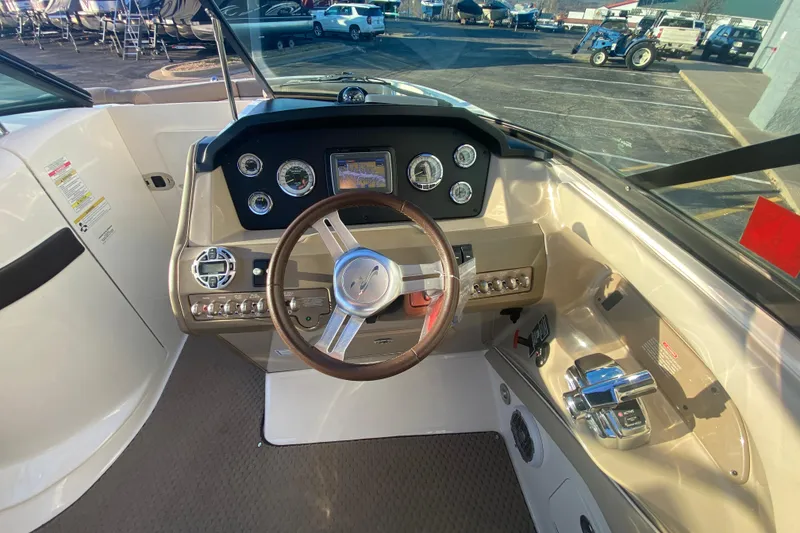 Slide: The Image of 2012 Sea Ray 300 SLX boat dashboard with steering wheel and control panel. - 28