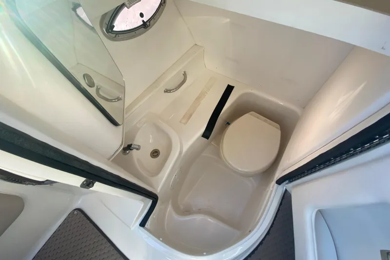 Slide: The Image of 2012 Sea Ray 300 SLX boat bathroom interior with sink and toilet. - 33