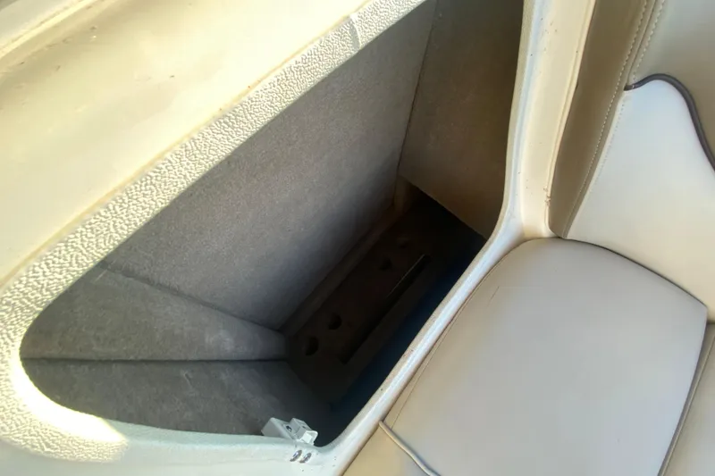 Slide: The Image of Storage compartment in 2012 Sea Ray 300 SLX boat, featuring beige upholstery and textured interior. - 37