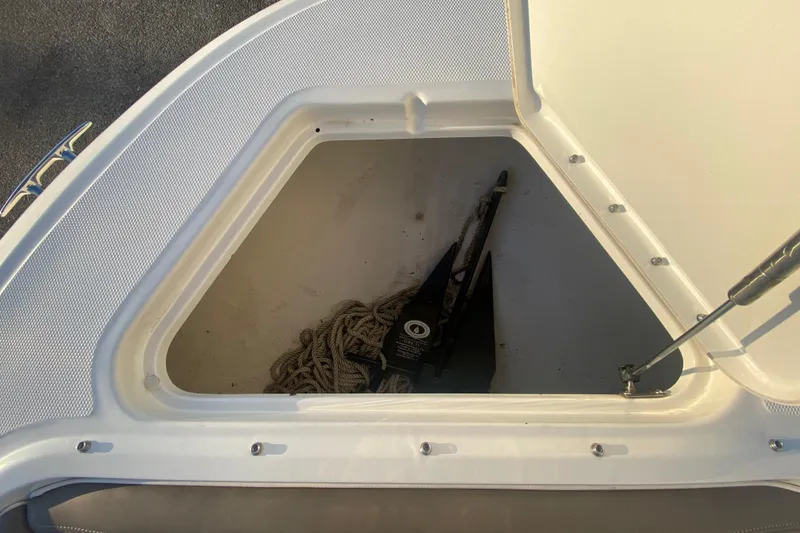 Slide: The Image of Open storage compartment on a 2012 Sea Ray 300 SLX boat, containing rope and anchor. - 38