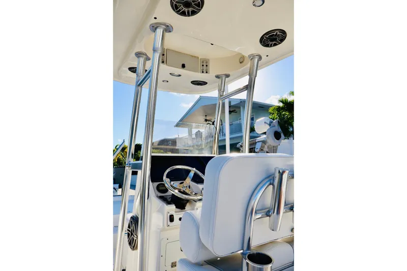 Slide: The Image of 2022 ShearWater 23LTZ boat interior with steering wheel and seating. - 11