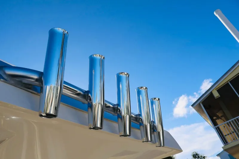 Slide: The Image of Chrome rod holders on 2022 ShearWater 23LTZ boat against blue sky. - 12