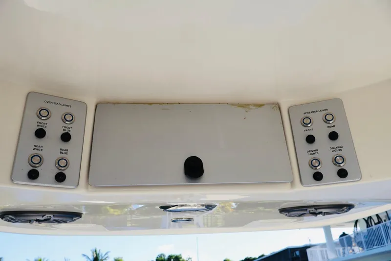 Slide: The Image of Control panel of 2022 ShearWater 23LTZ boat with overhead and spreader light switches. - 13