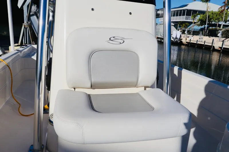 Slide: The Image of White seat on 2022 ShearWater 23LTZ boat, dockside view. - 15