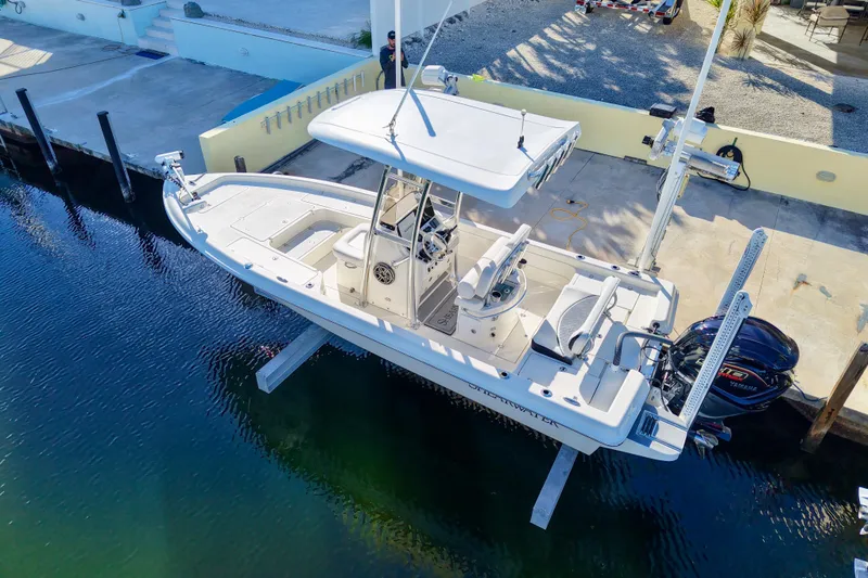 Slide: The Image of 2022 ShearWater 23LTZ boat docked, featuring a sleek design and Yamaha outboard motor. - 3