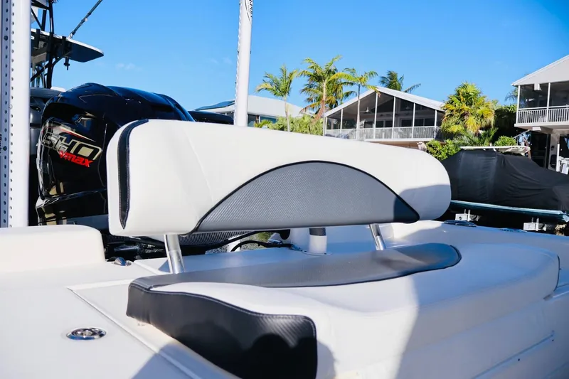 Slide: The Image of 2022 ShearWater 23LTZ boat with sleek seating and powerful engine, docked under clear skies. - 5