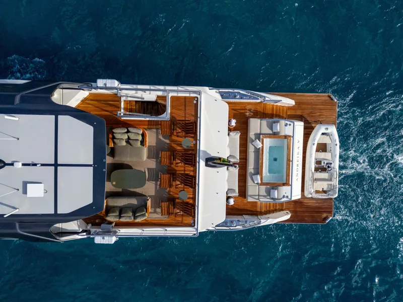 Slide: The Image of Luxurious 2025 Alpha 100 Squalo Co Ownership yacht "Euphoria" docked at night, illuminated in blue. - 13