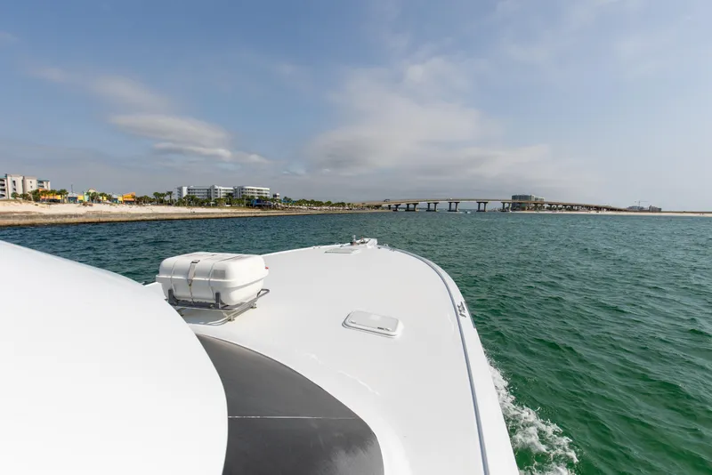 Slide: The Image of Hatteras 60 Convertible 2003 cruising on open sea with coastal view. - 16
