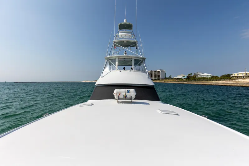 Slide: The Image of 2003 Hatteras 60 Convertible yacht on open water. - 17