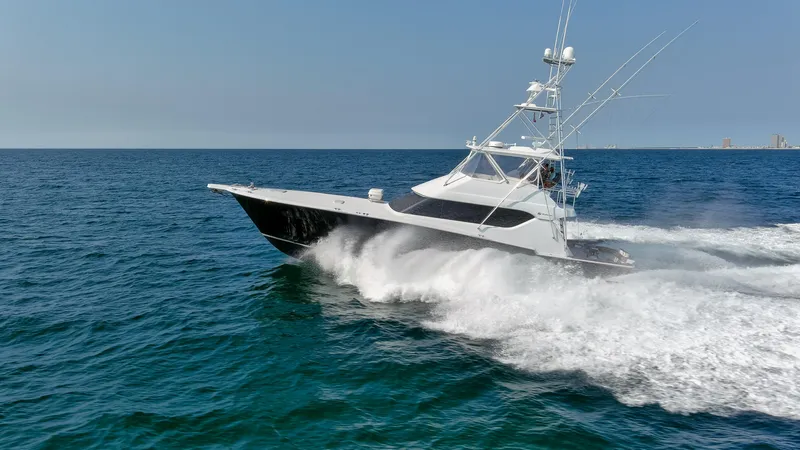 Slide: The Image of 2003 Hatteras 60 Convertible yacht cruising on open sea. - 21