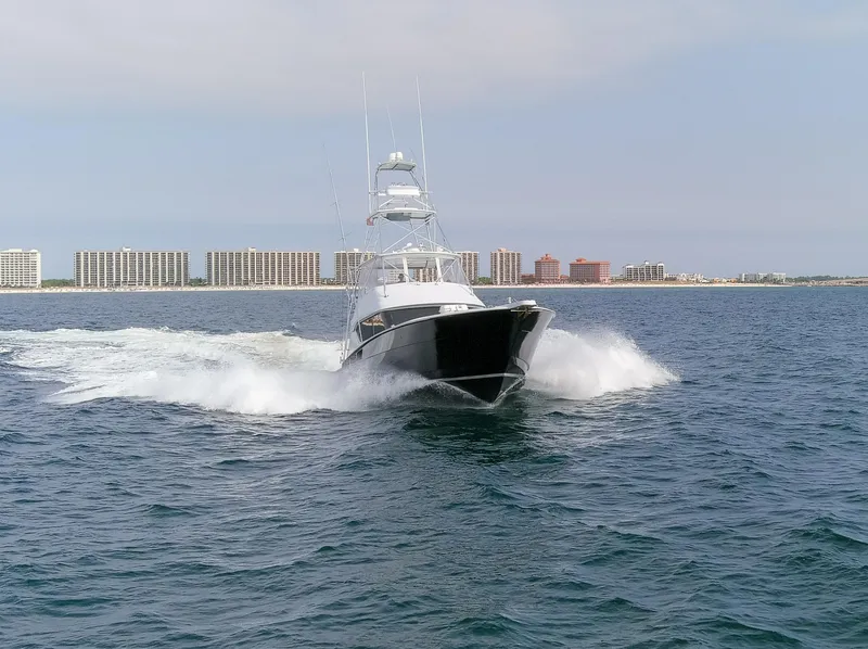 Slide: The Image of 2003 Hatteras 60 Convertible yacht cruising on the sea. - 24