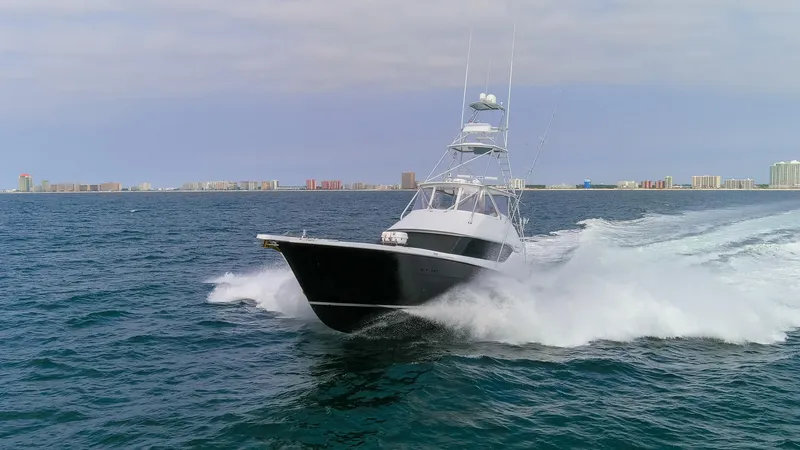 Slide: The Image of 2003 Hatteras 60 Convertible yacht cruising on open sea. - 31