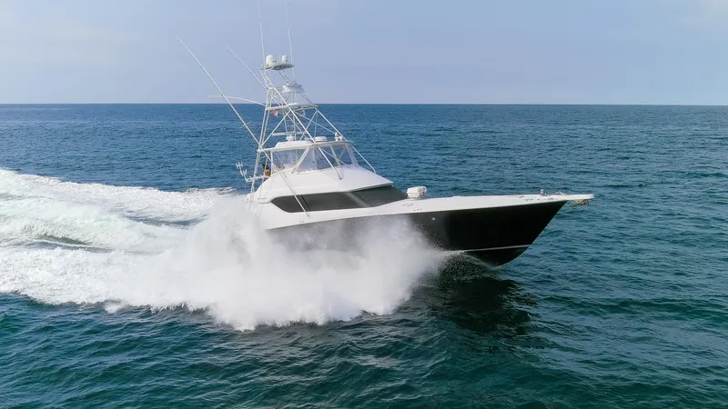 Slide: The Image of 2003 Hatteras 60 Convertible yacht cruising on open sea. - 35