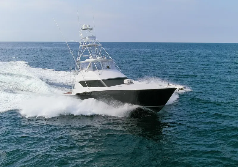 Slide: The Image of 2003 Hatteras 60 Convertible yacht cruising on open sea. - 36