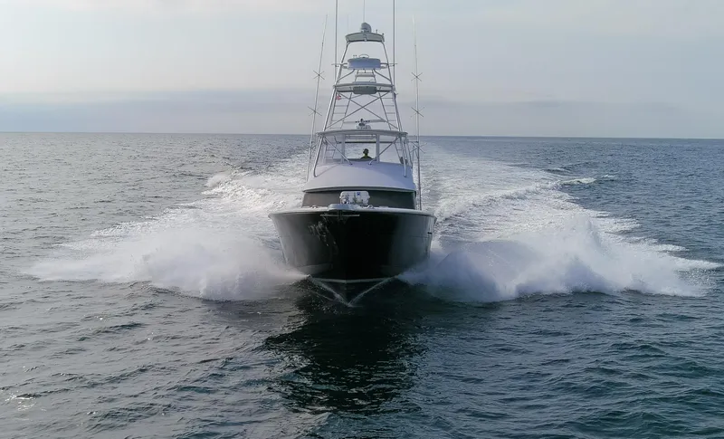 Slide: The Image of Hatteras 60 Convertible 2003 yacht cruising on open sea. - 38