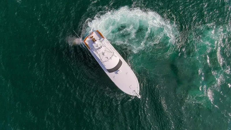 Slide: The Image of Aerial view of a 2003 Hatteras 60 Convertible yacht on the sea. - 41