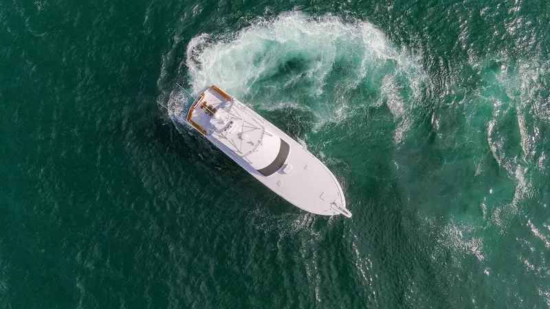 Slide: The Image of Aerial view of a Hatteras 60 Convertible yacht on the sea. - 42