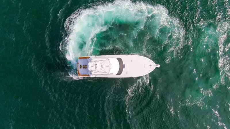Slide: The Image of Aerial view of a 2003 Hatteras 60 Convertible yacht on the sea. - 43