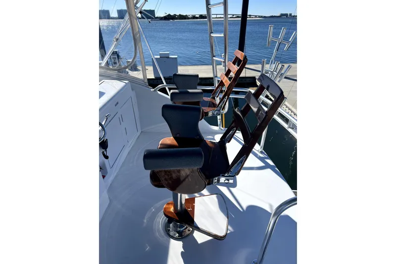 Slide: The Image of Captain's chairs on 2003 Hatteras 60 Convertible yacht, overlooking marina. - 71