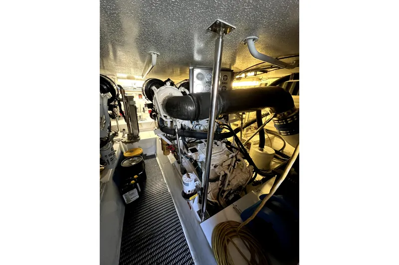 Slide: The Image of Engine room of 2003 Hatteras 60 Convertible yacht, showcasing machinery and components. - 73