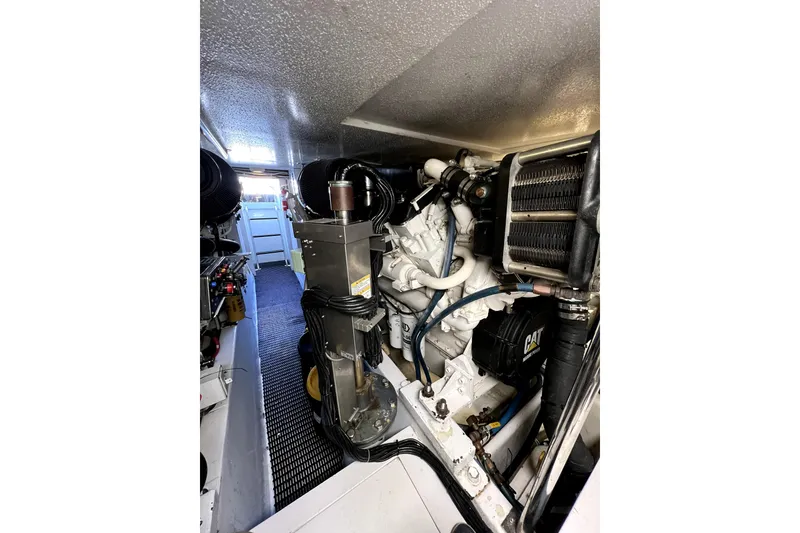 Slide: The Image of Engine room of 2003 Hatteras 60 Convertible yacht, featuring CAT machinery and components. - 74