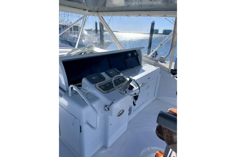 Slide: The Image of Helm of 2003 Hatteras 60 Convertible yacht with steering wheel and controls. - 76