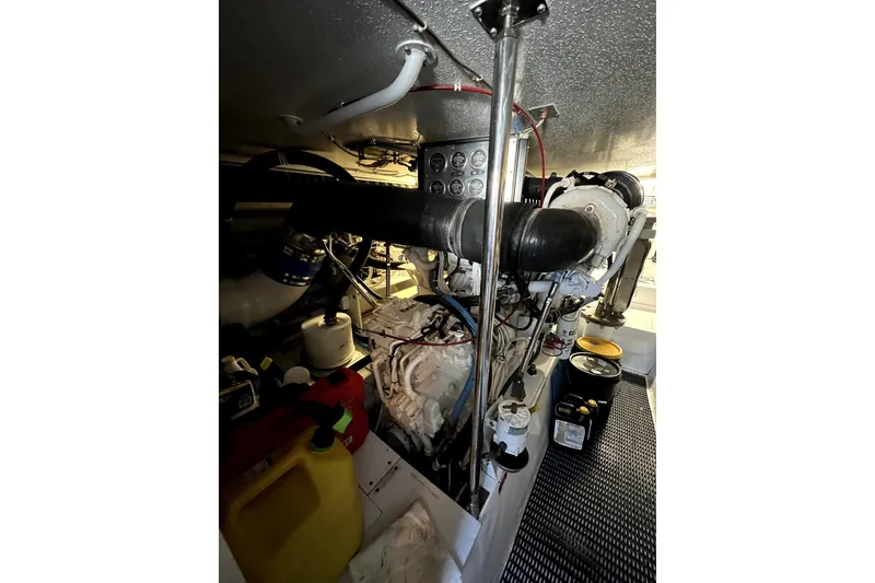 Slide: The Image of Engine room of 2003 Hatteras 60 Convertible yacht, showcasing mechanical components. - 80