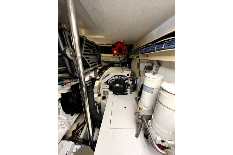 Slide: The Image of Engine room of 2003 Hatteras 60 Convertible yacht, showcasing mechanical components and systems. - 81