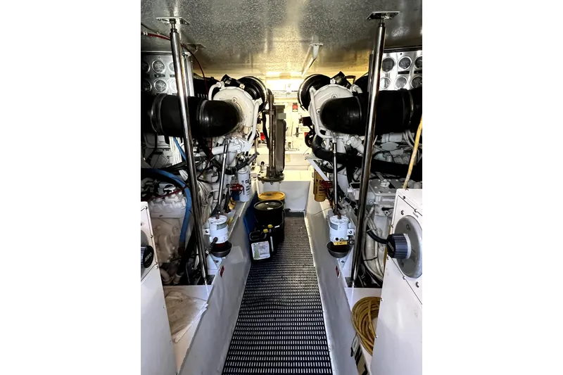 Slide: The Image of Engine room of 2003 Hatteras 60 Convertible yacht, showcasing dual engines and equipment. - 83