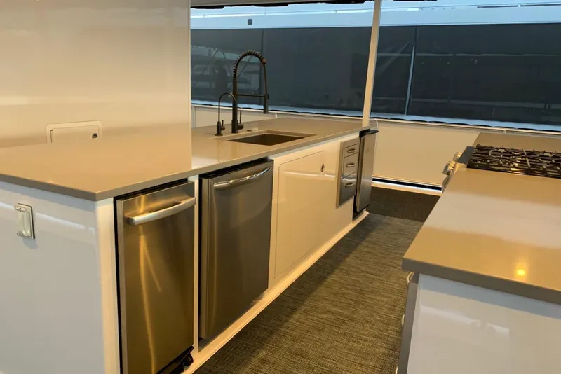 Slide: The Image of Modern yacht kitchen with stainless steel appliances, sleek countertops, and a stylish faucet. - 14