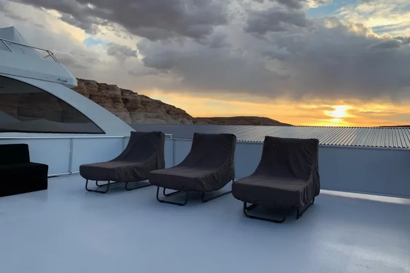 Slide: The Image of Sunset view from Adonia Utopia Trip #8 deck, featuring three lounge chairs, July 2019. - 18